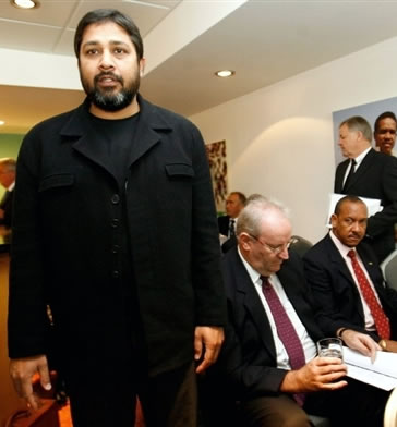 Inzamam-ul-Haq enters the room as Darrell Hair reads his papers during the ICC disciplinary hearing