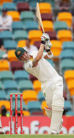 Michael Clarke drives down the ground