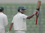 Nasir Hossain raises his bat after reaching his half-century