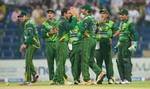 Pakistan players have a chat after dismissing a batsman